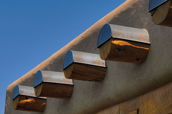 Log rafters, or vigas, extending from the inside are capped in copper to prevent rotting.